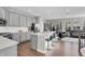 Open-concept kitchen with gray cabinets, quartz countertops, stainless steel appliances, and an island with seating at 3546 Brampton Ln, Westfield, IN 46074