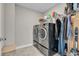 Clean laundry room with front load washer and dryer, wire shelving, and tile floors at 3546 Brampton Ln, Westfield, IN 46074
