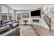 Cozy living room with a fireplace, large windows, comfortable seating, and hardwood floors at 3546 Brampton Ln, Westfield, IN 46074