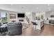 Open living area featuring a fireplace, stairs, and an open-concept kitchen with barstool seating at 3546 Brampton Ln, Westfield, IN 46074
