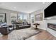 Inviting living room with a fireplace, large windows providing natural light, and hardwood floors at 3546 Brampton Ln, Westfield, IN 46074