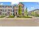 Townhomes with brick and siding exterior, black shutters, and green trees lining the street at 3546 Brampton Ln, Westfield, IN 46074