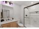 Contemporary bathroom with a wood vanity, marble countertops, and a glass-enclosed shower at 4078 Besbie Way, Bargersville, IN 46106
