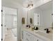 Bathroom featuring a dual vanity with modern fixtures and an open door to the Primary bedroom at 4078 Besbie Way, Bargersville, IN 46106