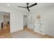 Bright bedroom boasts a ceiling fan, a neutral rug, wood floors, and a modern bookshelf at 4078 Besbie Way, Bargersville, IN 46106