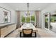 Modern dining room features a wooden table with seating, a contemporary light fixture, and sliding glass doors at 4078 Besbie Way, Bargersville, IN 46106