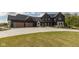 Stunning two-story home with a dark exterior, three-car garage, and professionally landscaped front yard at 4078 Besbie Way, Bargersville, IN 46106