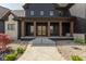 Inviting front porch with stone accents, wooden columns, a tiled walkway, and lush landscaping at 4078 Besbie Way, Bargersville, IN 46106