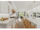 Bright, modern kitchen featuring marble countertops, pendant lights, and an open floor plan to the dining area at 4078 Besbie Way, Bargersville, IN 46106