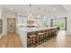 Bright, modern kitchen features a large island with bar seating, pendant lights, and stainless steel appliances at 4078 Besbie Way, Bargersville, IN 46106
