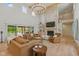 Bright living room boasting a floor-to-ceiling stone fireplace, wooden beams, and large sliding glass doors at 4078 Besbie Way, Bargersville, IN 46106