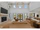 Inviting living room with a stone fireplace and large windows, offering an open layout with an adjacent kitchen at 4078 Besbie Way, Bargersville, IN 46106