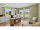 Inviting office with built-in shelving, natural light, a wood desk, and neutral-toned seating area at 4078 Besbie Way, Bargersville, IN 46106