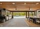 A lavish outdoor space featuring a full kitchen, a pool, and a dining area with a beautifully stained wood ceiling at 4078 Besbie Way, Bargersville, IN 46106