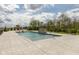 A luxurious outdoor pool with a basketball hoop and a stone water feature against a lush backdrop at 4078 Besbie Way, Bargersville, IN 46106