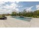 A gorgeous outdoor pool with a basketball hoop and diving board surrounded by concrete tiling at 4078 Besbie Way, Bargersville, IN 46106