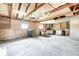 Unfinished garage featuring an overhead door, exposed wooden beams, and concrete floors at 423 W Janet Dr, Brownsburg, IN 46112
