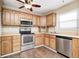 Functional kitchen featuring stainless steel appliances, light wood cabinets and a stainless steel sink at 423 W Janet Dr, Brownsburg, IN 46112