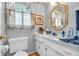 Bright bathroom with a single sink vanity, a mirror, and a window with natural light at 4232 Briarwood Dr, Indianapolis, IN 46250