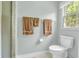 Cozy, bright bathroom with a clean white toilet next to a window with natural light at 4232 Briarwood Dr, Indianapolis, IN 46250