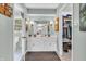 Bright bathroom with double vanity, framed mirror, and view into the closet at 4232 Briarwood Dr, Indianapolis, IN 46250