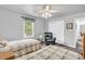 Comfortable bedroom featuring twin beds, a window, and a cozy armchair at 4232 Briarwood Dr, Indianapolis, IN 46250