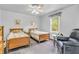 Comfortable bedroom featuring twin beds, a window, and a cozy armchair at 4232 Briarwood Dr, Indianapolis, IN 46250