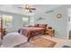 Comfortable bedroom with natural light, a ceiling fan, and a view of the outdoors at 4232 Briarwood Dr, Indianapolis, IN 46250