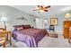 Well-lit bedroom with ceiling fan, wood furniture, and decorative details throughout at 4232 Briarwood Dr, Indianapolis, IN 46250