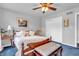 Cozy bedroom with hardwood floors, a plush bed, and a decorative bench at 4232 Briarwood Dr, Indianapolis, IN 46250