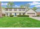Charming two-story home with a well-manicured lawn and a beautiful blue front door at 4232 Briarwood Dr, Indianapolis, IN 46250