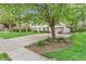 Home exterior with lush lawn and mature trees, complemented by a wide driveway at 4232 Briarwood Dr, Indianapolis, IN 46250