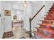 Warm and inviting foyer featuring a staircase and views into the living spaces at 4232 Briarwood Dr, Indianapolis, IN 46250