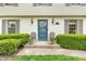 Close-up of the home's entrance, featuring a blue door and manicured shrubbery at 4232 Briarwood Dr, Indianapolis, IN 46250