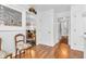 Hallway with hardwood floors, access to the staircase, and decorated transom at 4232 Briarwood Dr, Indianapolis, IN 46250