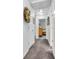 Hallway view leading to a bedroom with carpeted floor and white doors at 4232 Briarwood Dr, Indianapolis, IN 46250