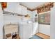 Functional laundry room with a washer, dryer, utility sink, and storage cabinets at 4232 Briarwood Dr, Indianapolis, IN 46250