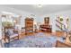 Spacious living room featuring a piano, hardwood floors, area rug, and decorative furniture at 4232 Briarwood Dr, Indianapolis, IN 46250