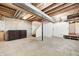 Spacious unfinished basement offering ample storage and renovation potential with stairs to the first floor at 4302 Kessler Blvd N Dr, Indianapolis, IN 46220