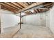 Unfinished basement featuring concrete walls, support beams, and exposed ceiling, offering potential for customization at 4302 Kessler Blvd N Dr, Indianapolis, IN 46220