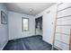 Cozy bedroom features carpet, window, closet, and ladder, offering a comfortable and private space at 4302 Kessler Blvd N Dr, Indianapolis, IN 46220