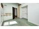 Bedroom area features an open closet, doors to the outside, a ladder, and carpet flooring at 4302 Kessler Blvd N Dr, Indianapolis, IN 46220