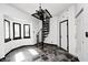 Entryway featuring a distinctive spiral staircase and unique stone floors at 4302 Kessler Blvd N Dr, Indianapolis, IN 46220