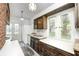 Cozy kitchen with dark wood cabinets, white countertops, and bright natural light at 4302 Kessler Blvd N Dr, Indianapolis, IN 46220