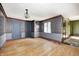 Empty room with wood floors, wallpaper, and blue trim is ready for personalization at 4302 Kessler Blvd N Dr, Indianapolis, IN 46220