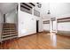 Bright living room boasts hardwood floors, stairs, large windows, and a railing to the upstairs area at 4302 Kessler Blvd N Dr, Indianapolis, IN 46220