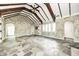 This living room boasts stone walls, beamed ceilings, stone floors, and multiple entrances at 4302 Kessler Blvd N Dr, Indianapolis, IN 46220