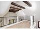 Loft area displays wood beams, white railings, a fan, and two windows for natural lighting at 4302 Kessler Blvd N Dr, Indianapolis, IN 46220