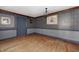 Empty room with wood floors, wallpaper, and blue trim ready for personalization at 4302 Kessler Blvd N Dr, Indianapolis, IN 46220