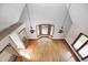 Top-down view of the living room shows hardwood floors, modern chandelier, and stairs to another room at 4302 Kessler Blvd N Dr, Indianapolis, IN 46220